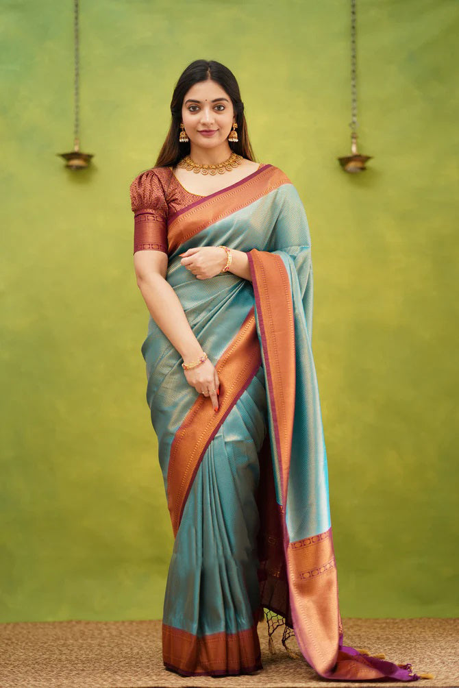 Embrocation Firozi Soft Banarasi Silk Saree With Ephemeral Blouse Piece