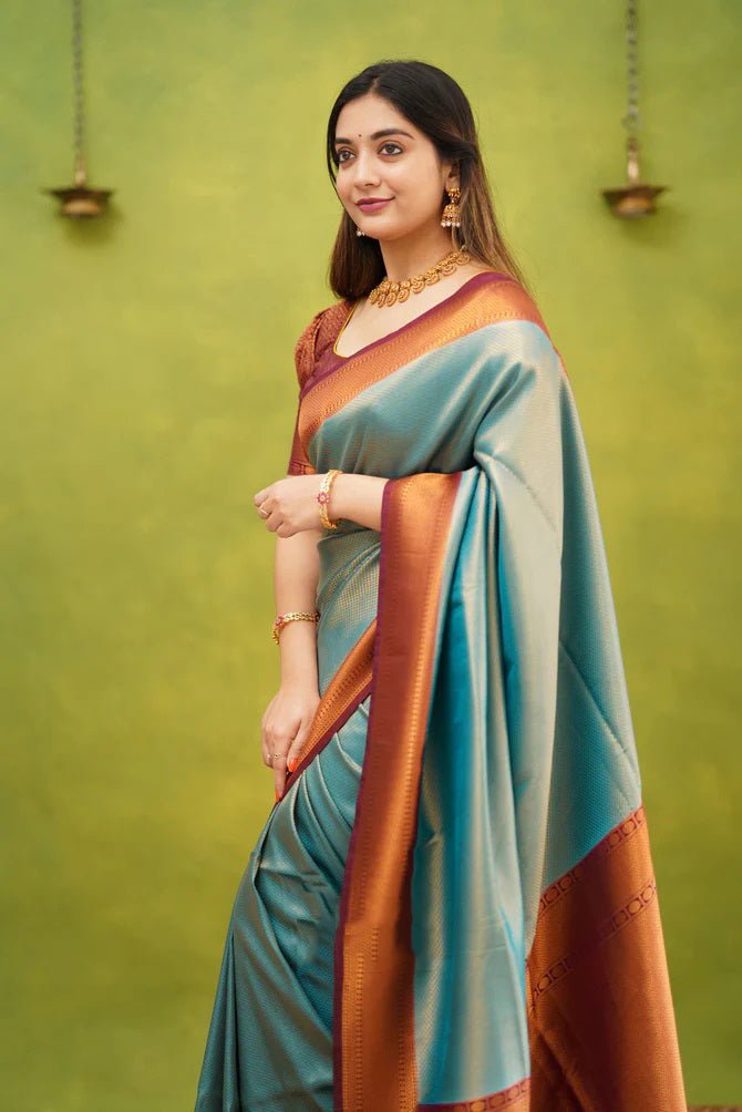 Embrocation Firozi Soft Banarasi Silk Saree With Ephemeral Blouse Piece